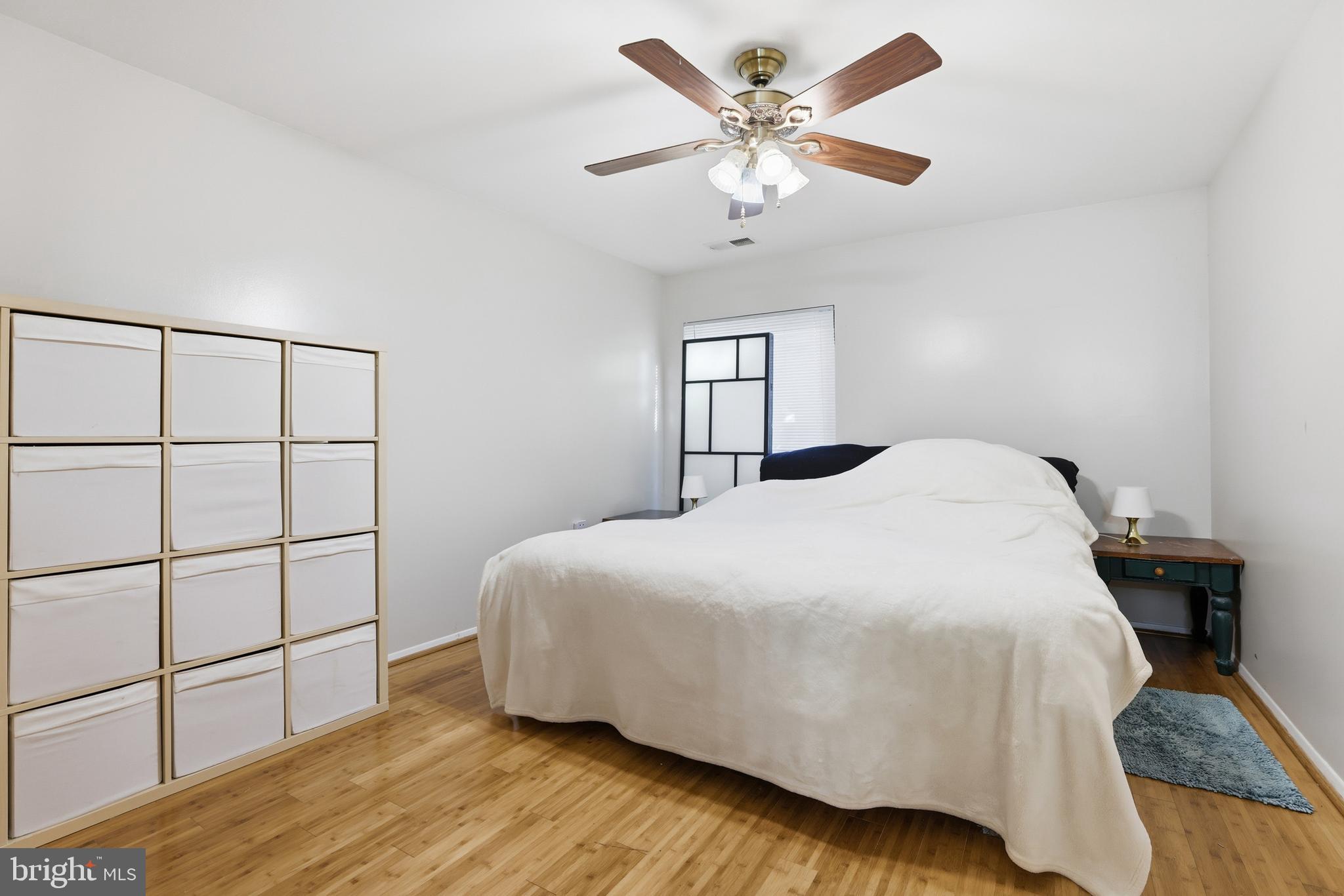 427 Christopher Avenue, Unit T2 Gaithersburg, MD 20879 - Photo 19 of 28 a bedroom with a bed and a chandelier