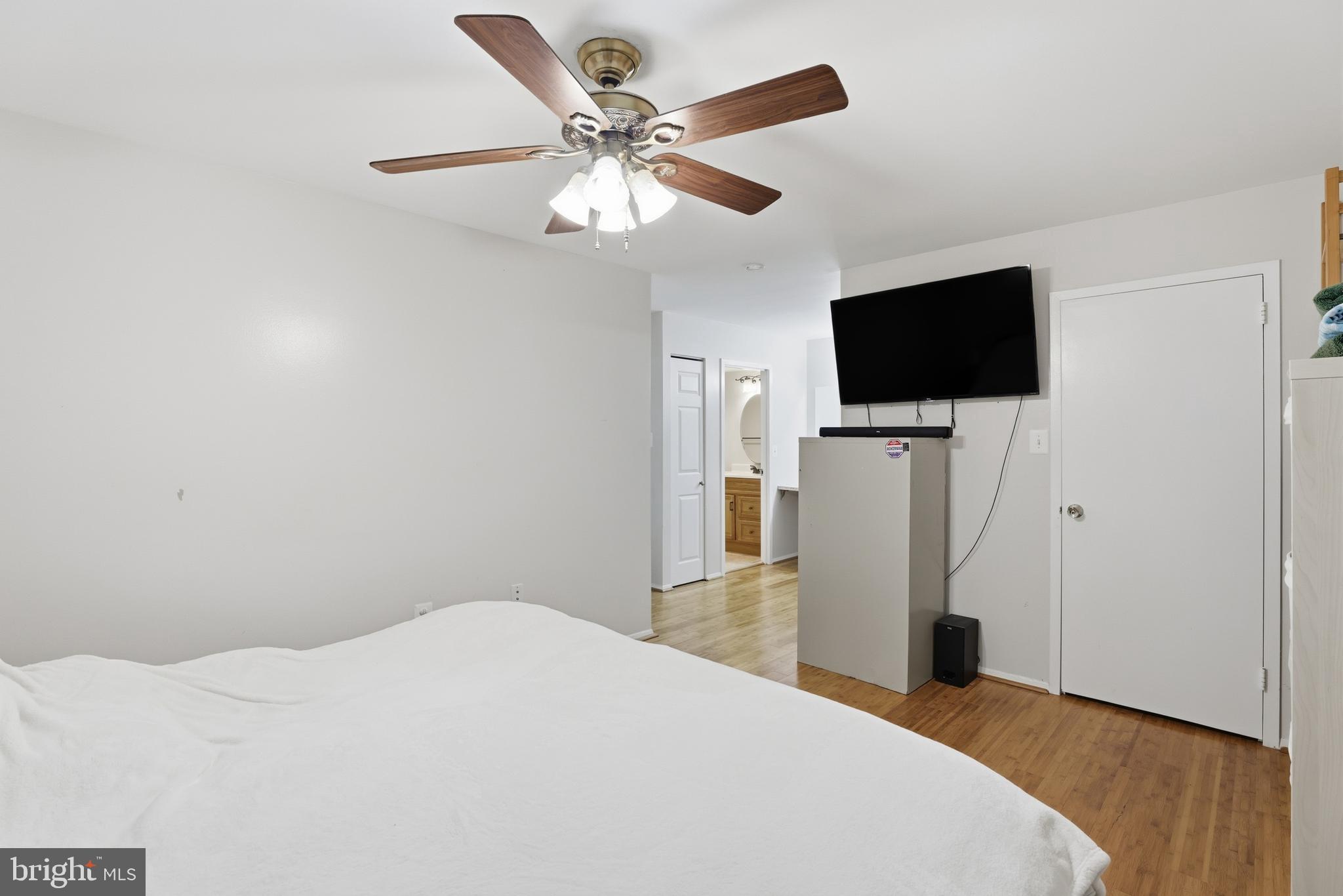 427 Christopher Avenue, Unit T2 Gaithersburg, MD 20879 - Photo 20 of 28 a bedroom with a bed and a flat screen tv