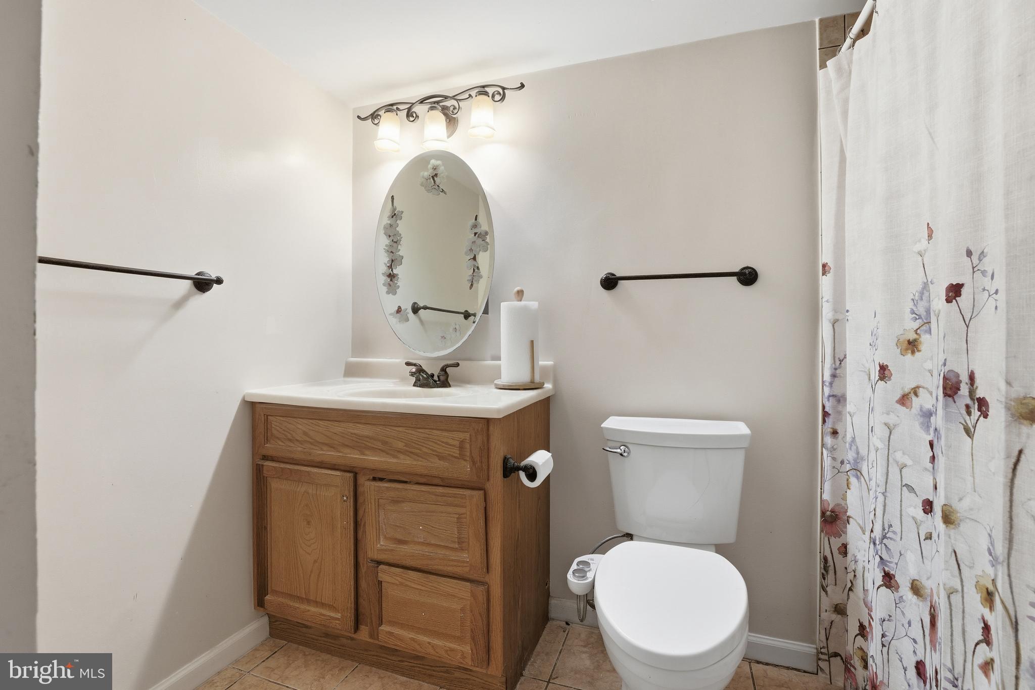 427 Christopher Avenue, Unit T2 Gaithersburg, MD 20879 - Photo 23 of 28 a bathroom with a toilet sink and mirror