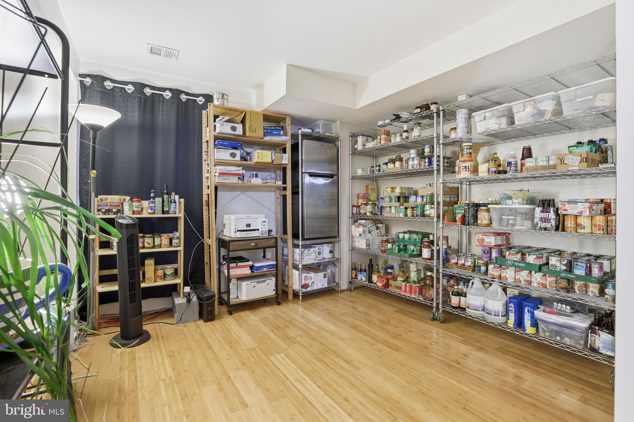 427 Christopher Avenue, Unit T2 Gaithersburg, MD 20879 - Photo 25 of 28 a room with lots of wooden furniture and a book shelf