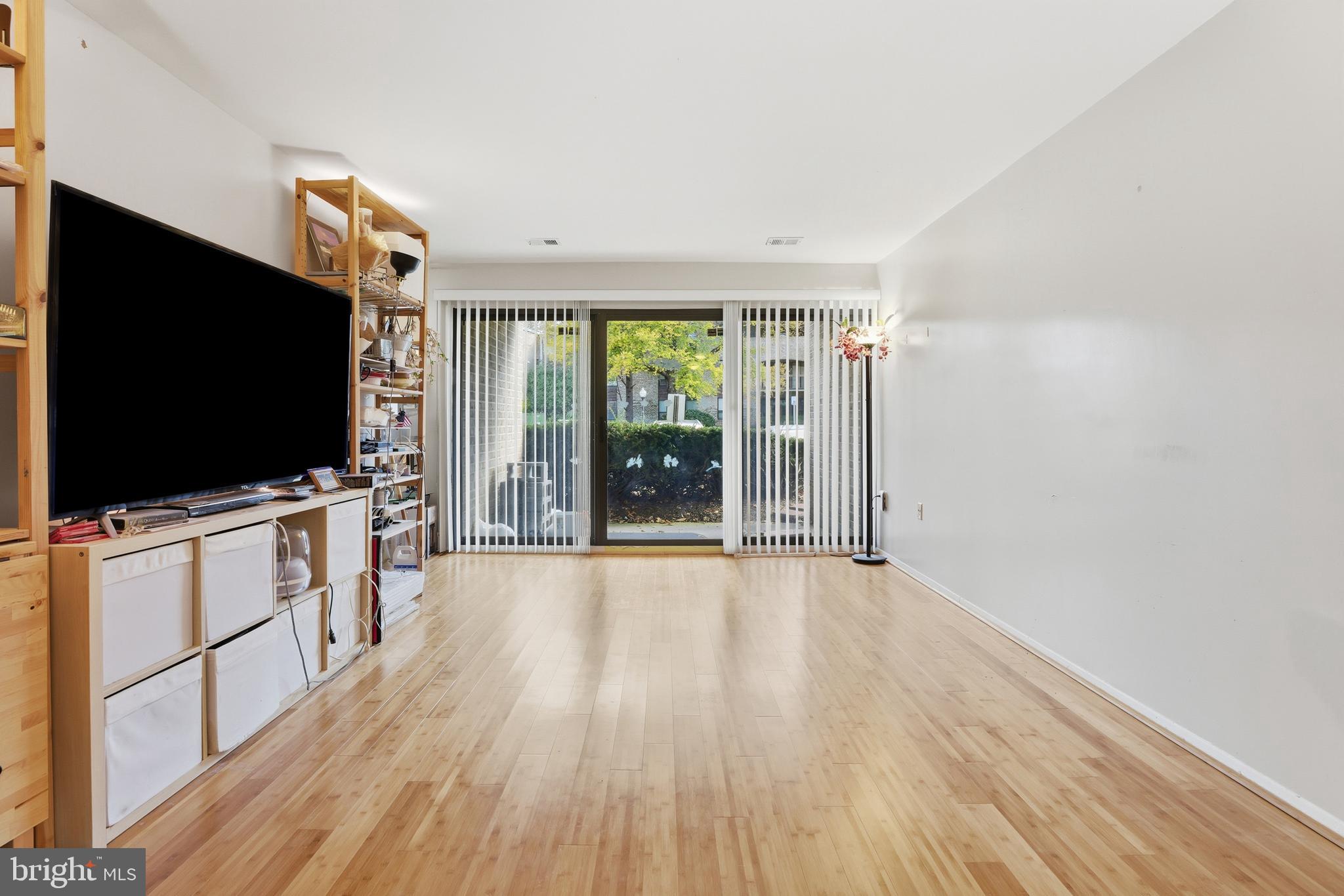 427 Christopher Avenue, Unit T2 Gaithersburg, MD 20879 - Photo 10 of 28 a view of a livingroom with furniture flat screen tv and floor to ceiling window