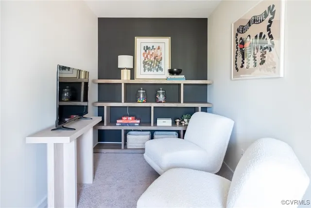 a living room with furniture a rug and a window