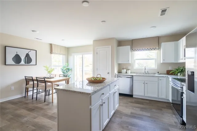 a kitchen with sink cabinets and window