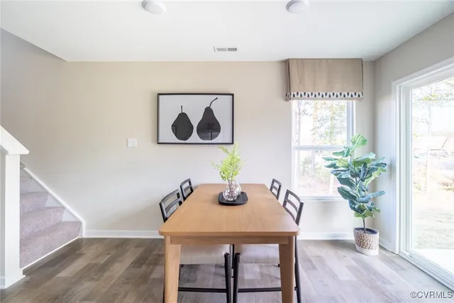 a view of a dining room with furniture window and wooden floor