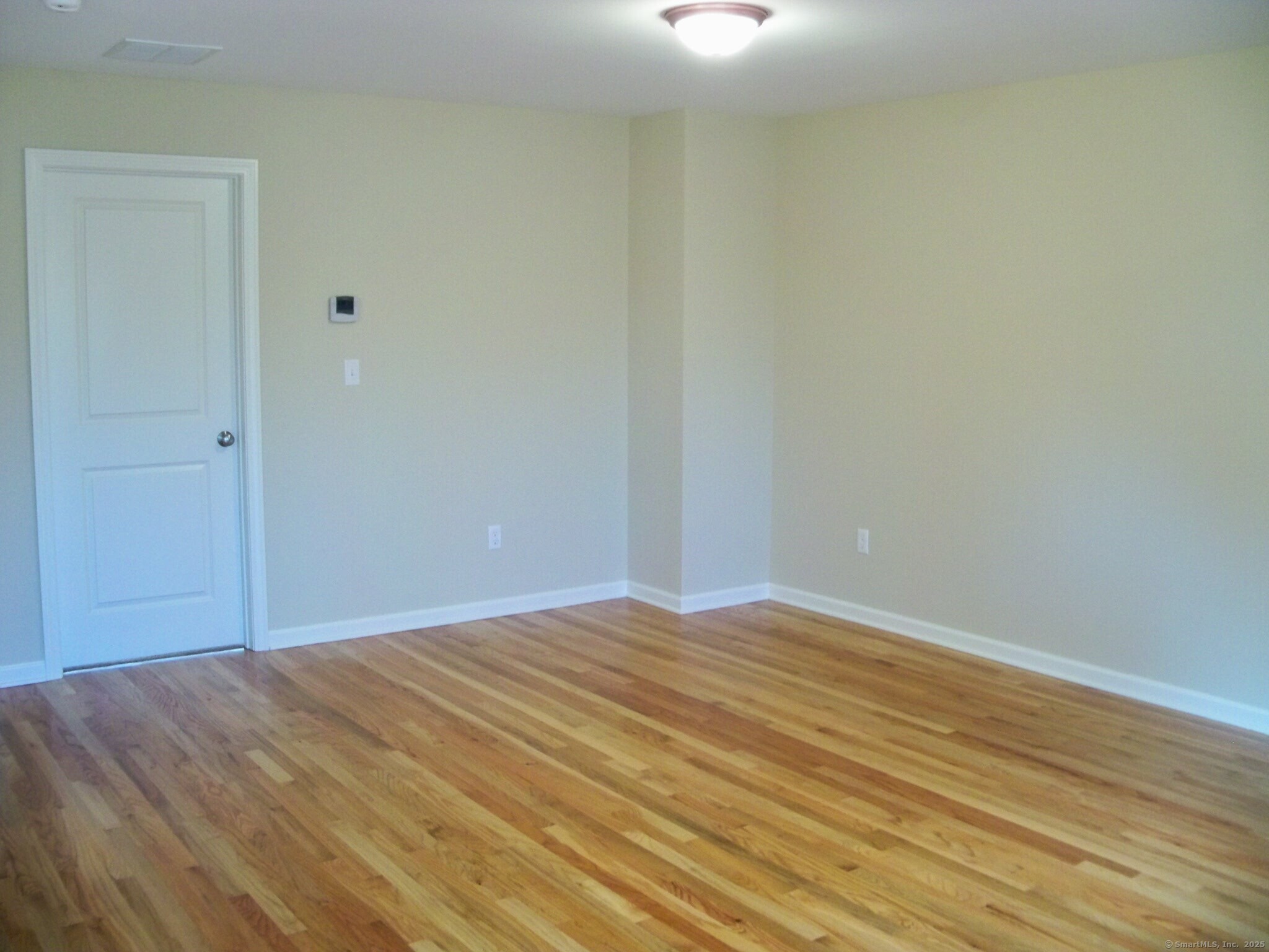 404 Main Street, Unit 13 Wallingford, CT 06492 - Photo 12 of 19 a view of empty room with wooden floor