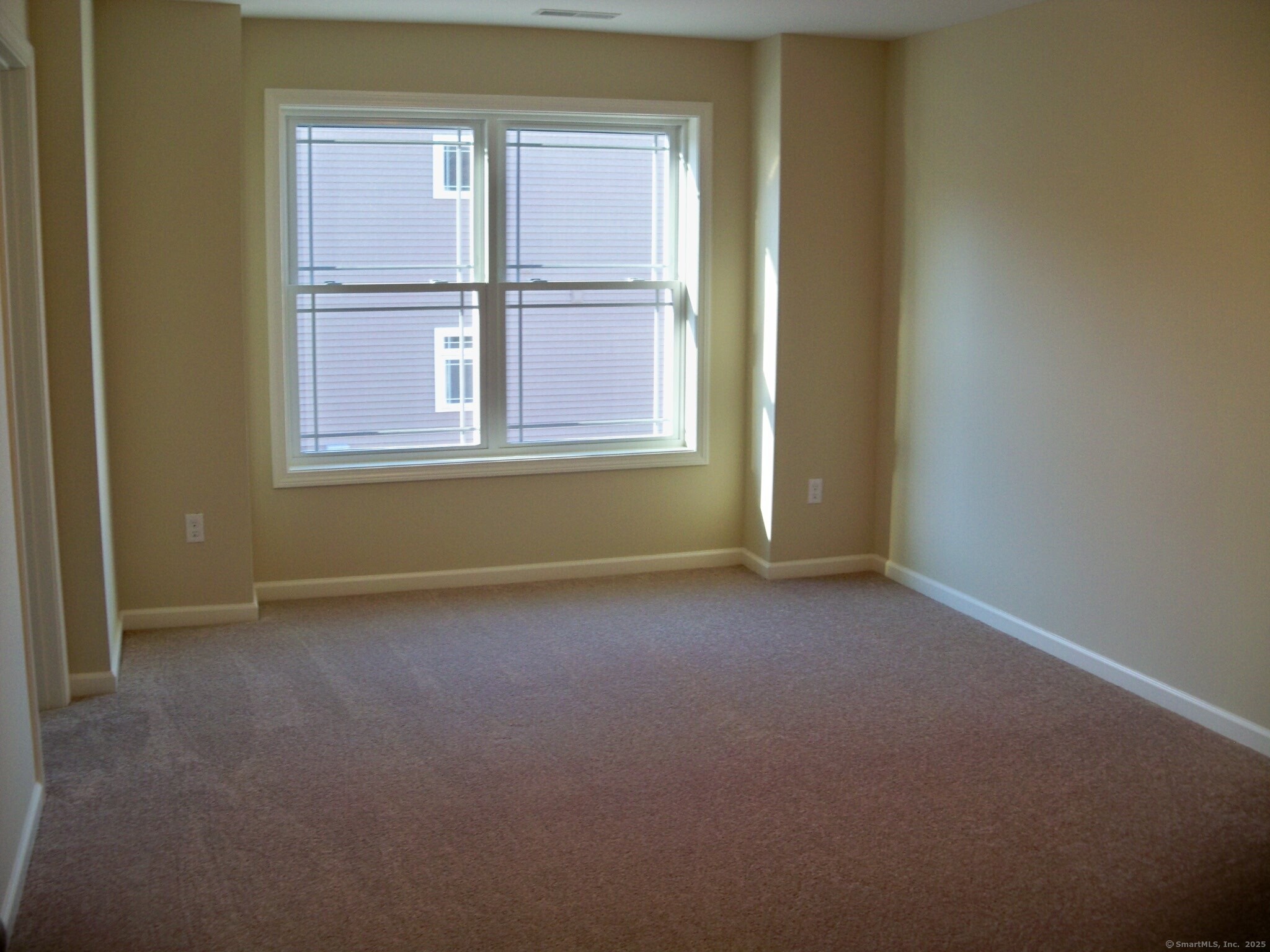 404 Main Street, Unit 13 Wallingford, CT 06492 - Photo 16 of 19 an empty room with windows