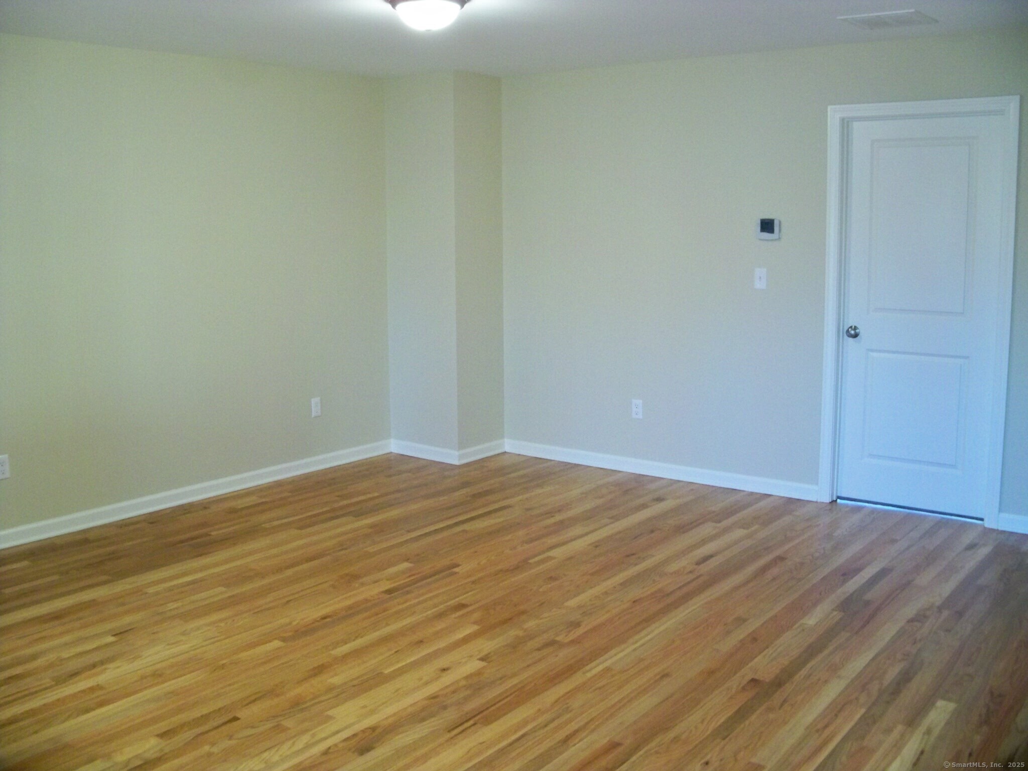 404 Main Street, Unit 13 Wallingford, CT 06492 - Photo 9 of 19 a view of empty room with wooden floor