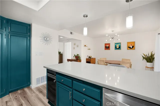 a living room with furniture a large window and wooden floor