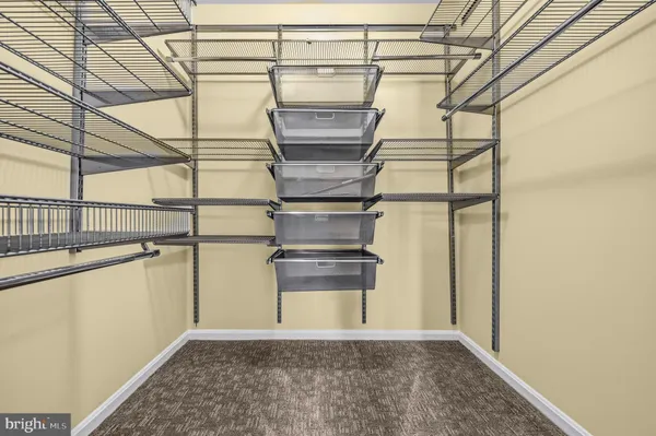 an empty room with closet and ceiling fan