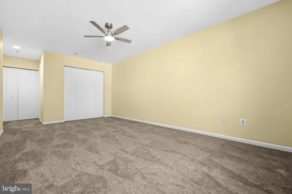a view of an empty room with a ceiling fan