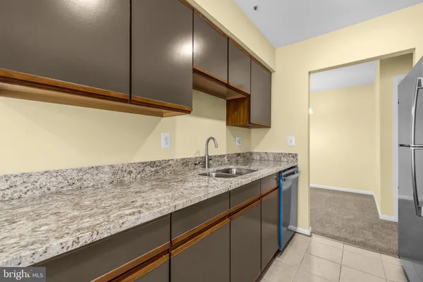 a kitchen with sink and cabinets