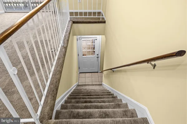 a view of a livingroom with wooden floor and windows