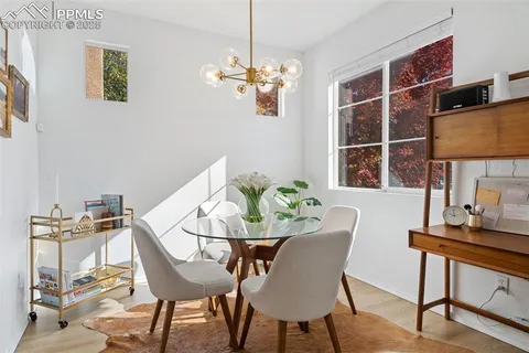 a view of a dining room with furniture and chandelier