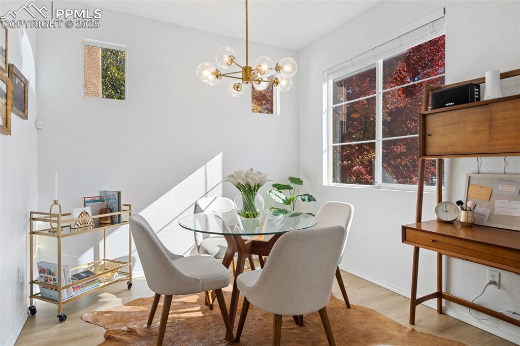 3231 Apogee View Colorado Springs, CO 80906 - Photo 12 of 38 a view of a dining room with furniture and chandelier