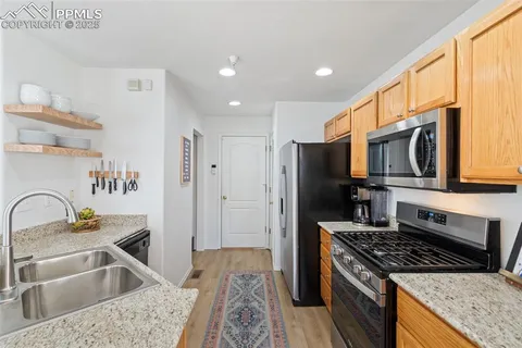 a kitchen with a sink stove and refrigerator