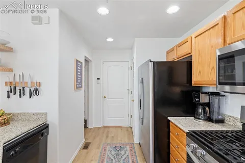 a kitchen with a refrigerator and a stove