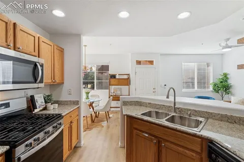 a kitchen with a sink stove top oven and microwave
