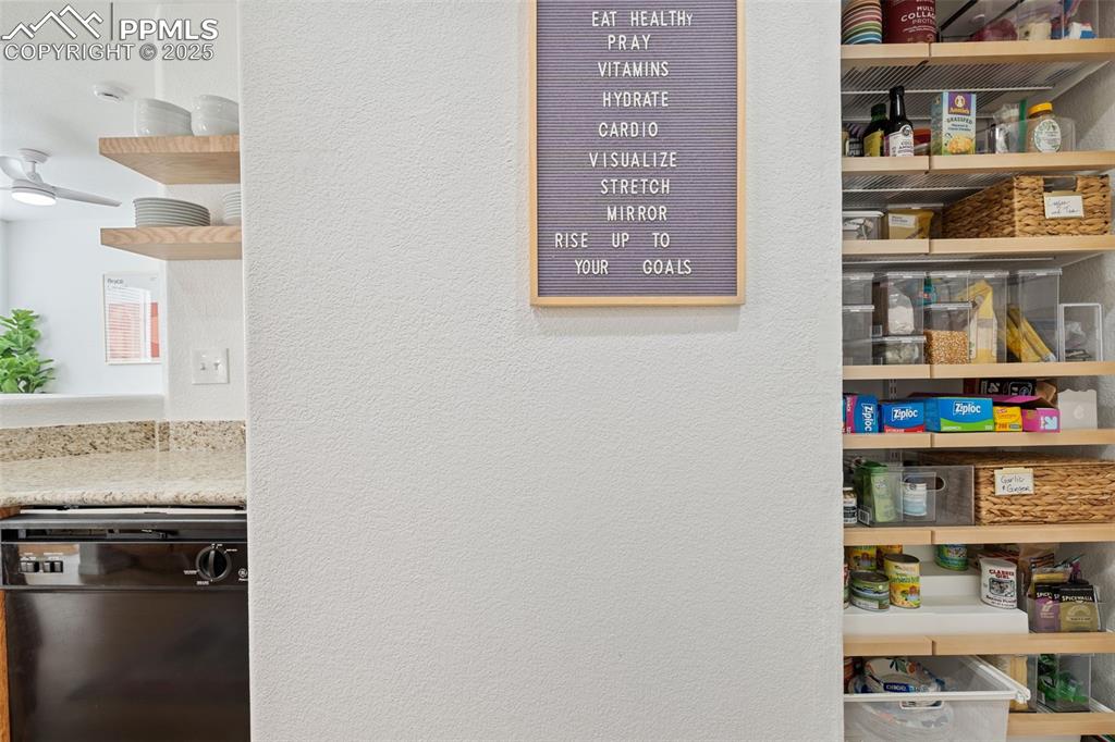 3231 Apogee View Colorado Springs, CO 80906 - Photo 20 of 38 a shelf with books and knick knacks on it