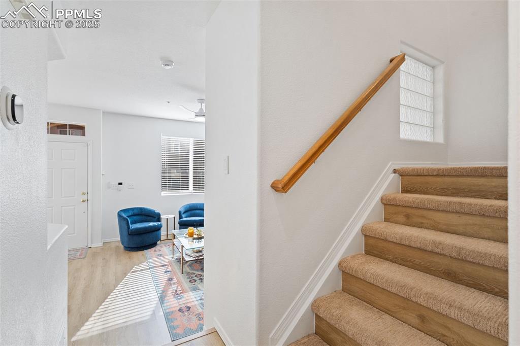 3231 Apogee View Colorado Springs, CO 80906 - Photo 22 of 38 a view of hallway with stairs and wooden floor