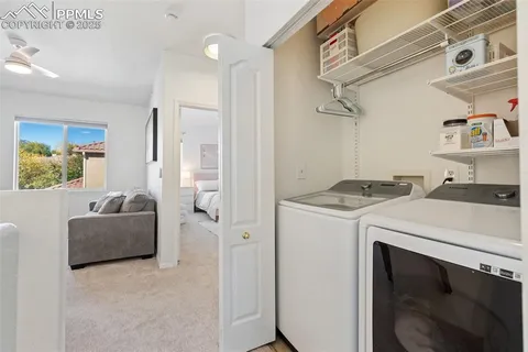 a living room with a stove and a refrigerator