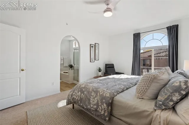 a bedroom with a bed and a mirror