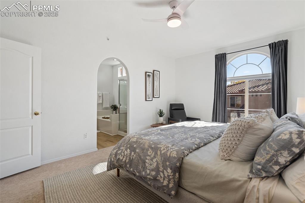3231 Apogee View Colorado Springs, CO 80906 - Photo 25 of 38 a bedroom with a bed and a mirror