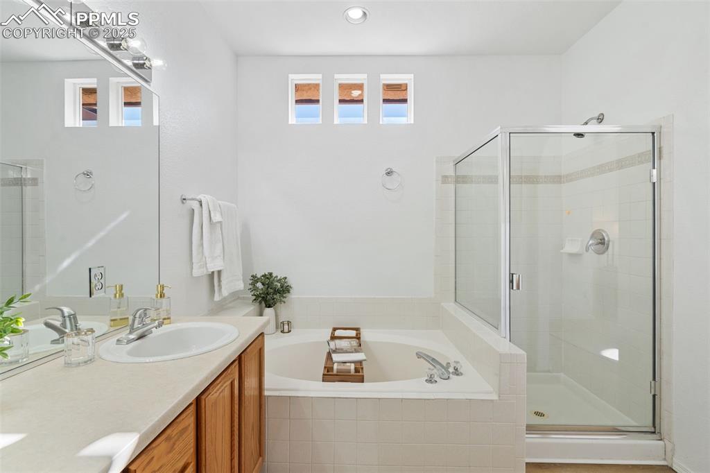 3231 Apogee View Colorado Springs, CO 80906 - Photo 28 of 38 a bathroom with a sink a shower and a mirror