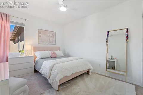 a bedroom with a bed and a painting on the wall