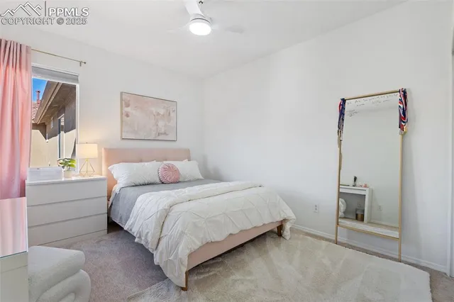 a bedroom with a bed and a painting on the wall