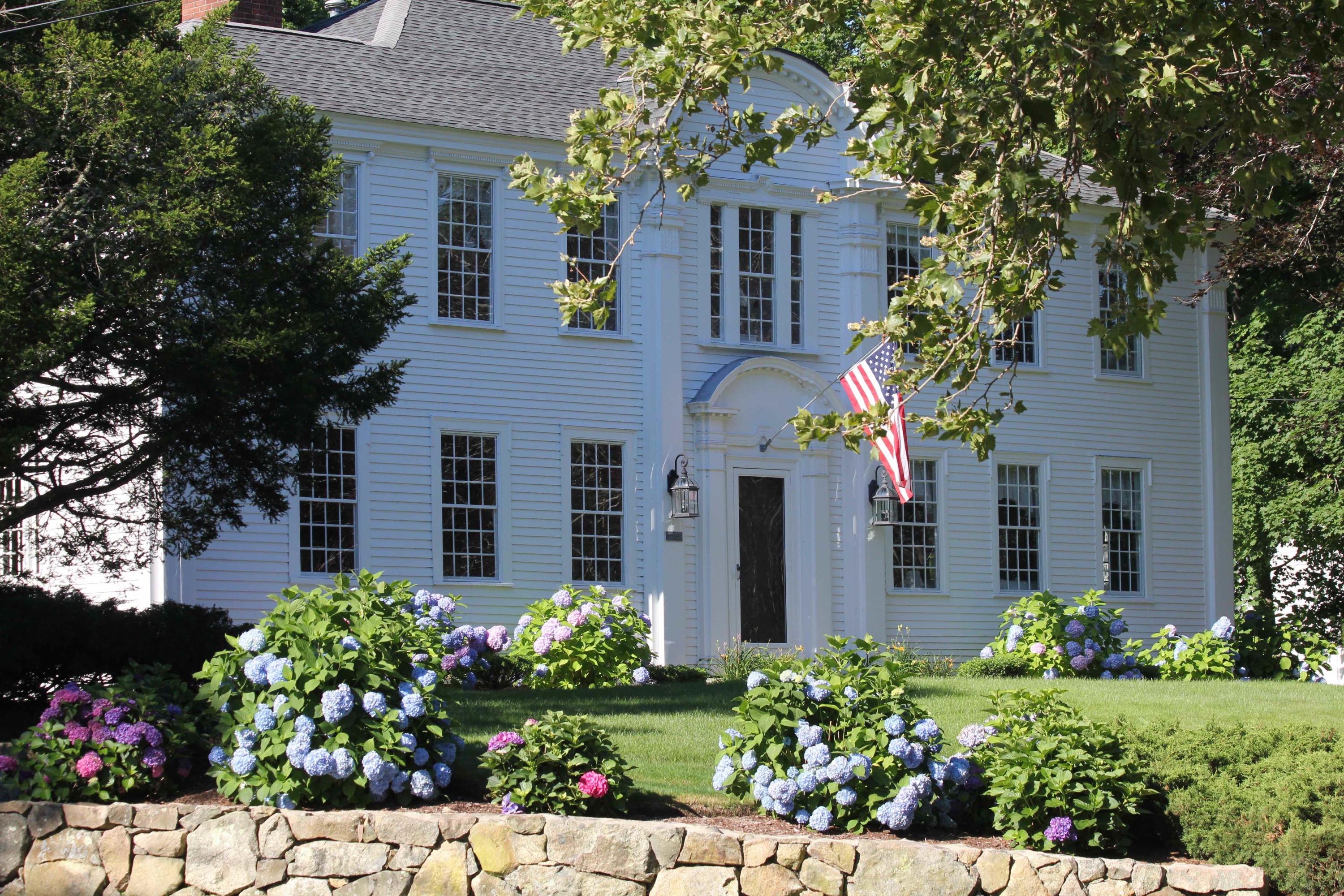 a front view of a house with a yard and flowers
