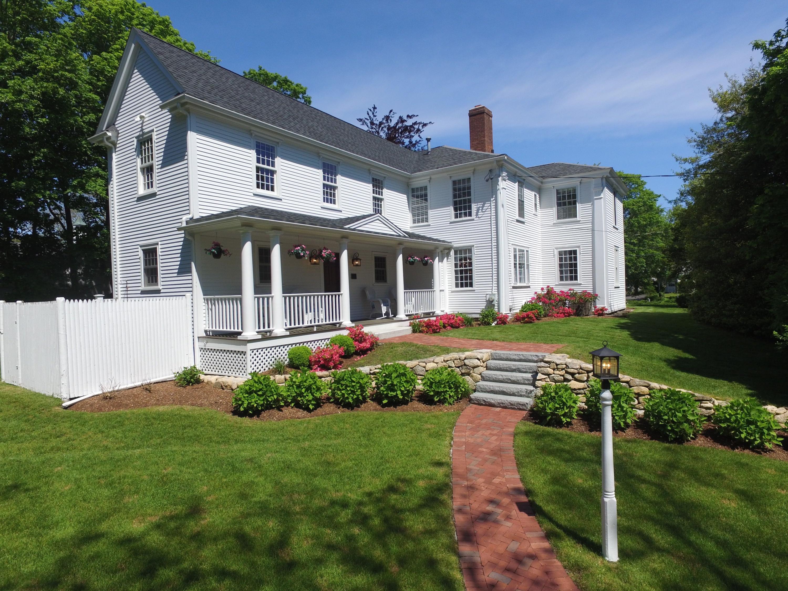 9 East Bay Road Osterville, MA 02655 - Photo 2 of 30 a front view of a house with a garden and plants