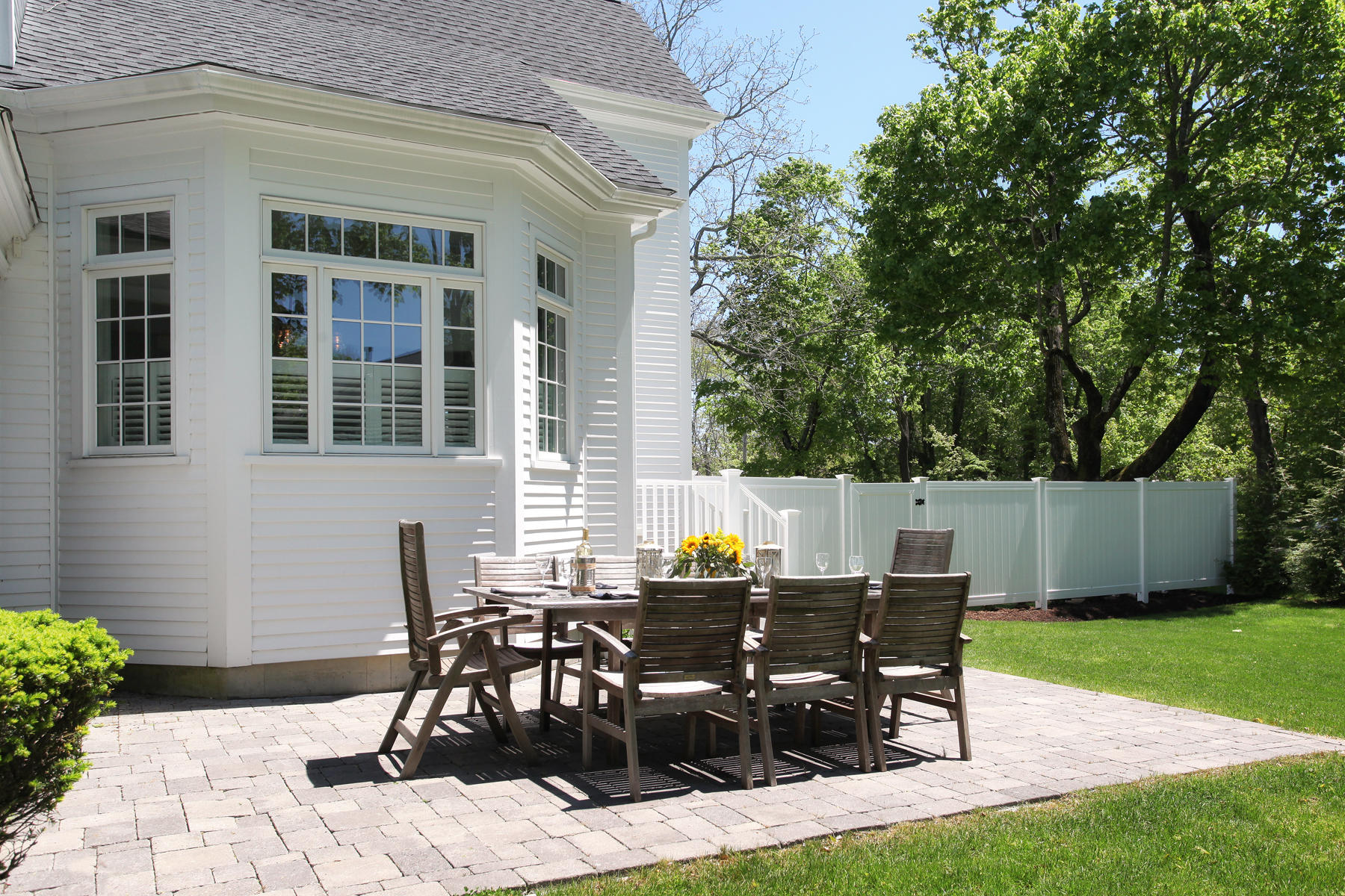 9 East Bay Road Osterville, MA 02655 - Photo 27 of 30 a view of a patio with table and chairs and garden