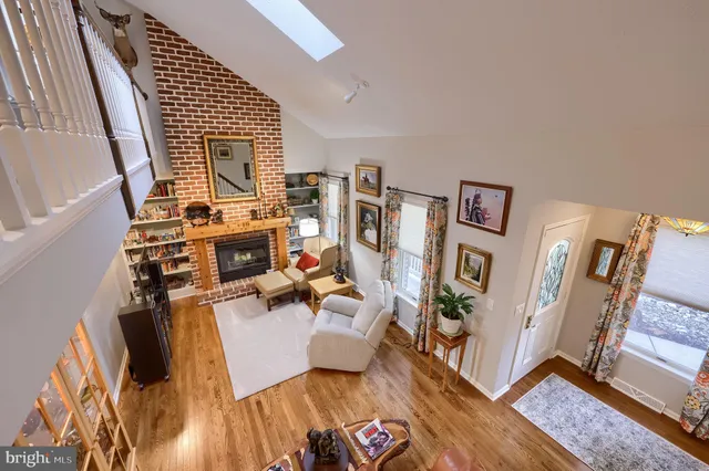 a view of a hallway with wooden floor and stairs