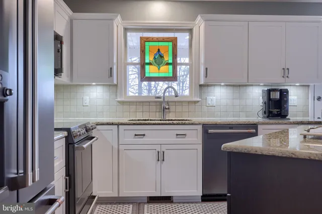 a kitchen with a stove a sink and a refrigerator