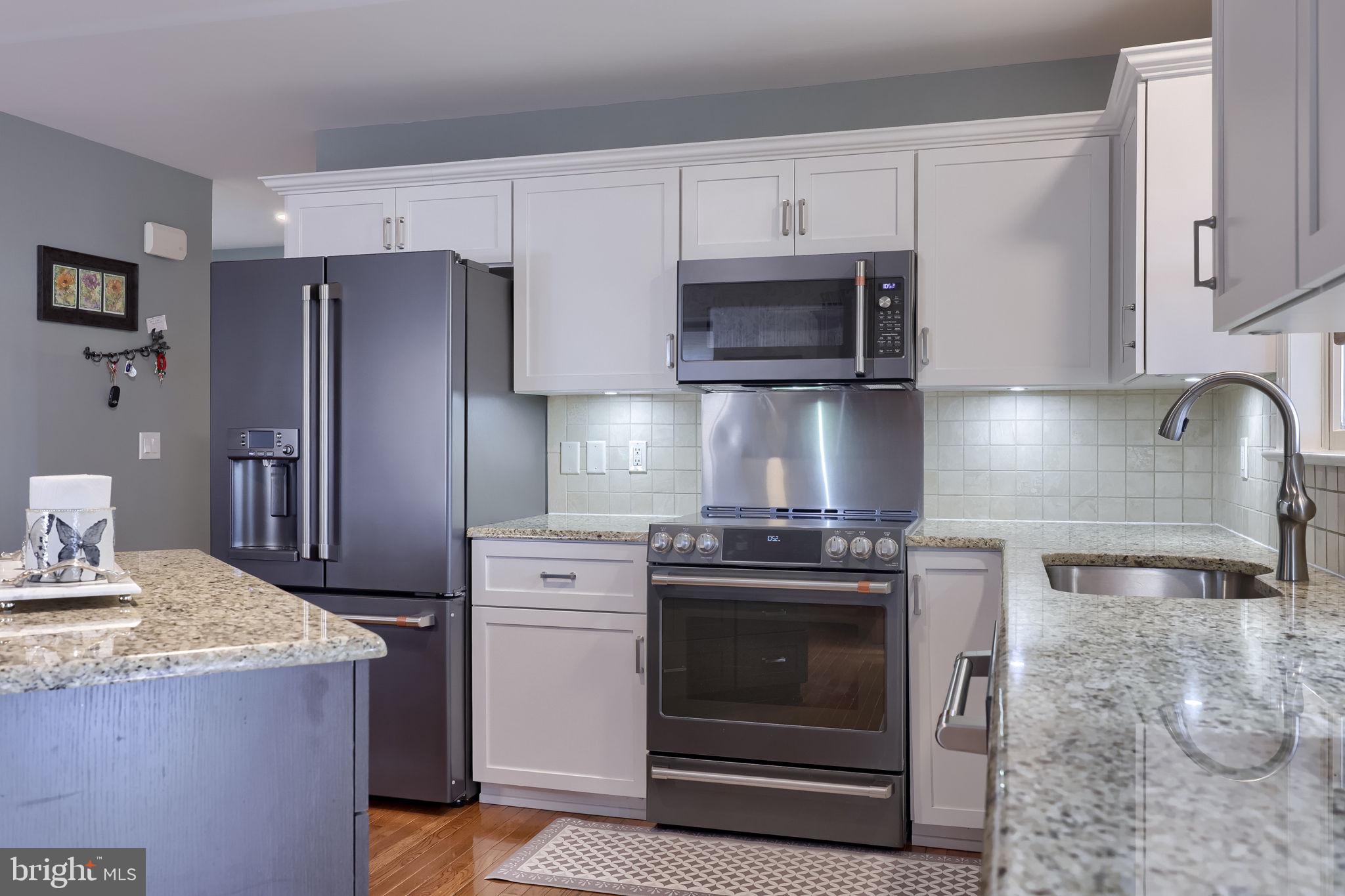 58 Timber Villa Elizabethtown, PA 17022 - Photo 28 of 60 a kitchen with stainless steel appliances granite countertop a stove a refrigerator and a microwave