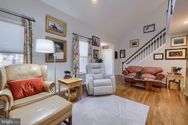 a living room with furniture a fireplace and a large window