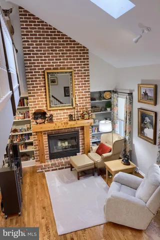 a view of a living room with furniture and wooden floor