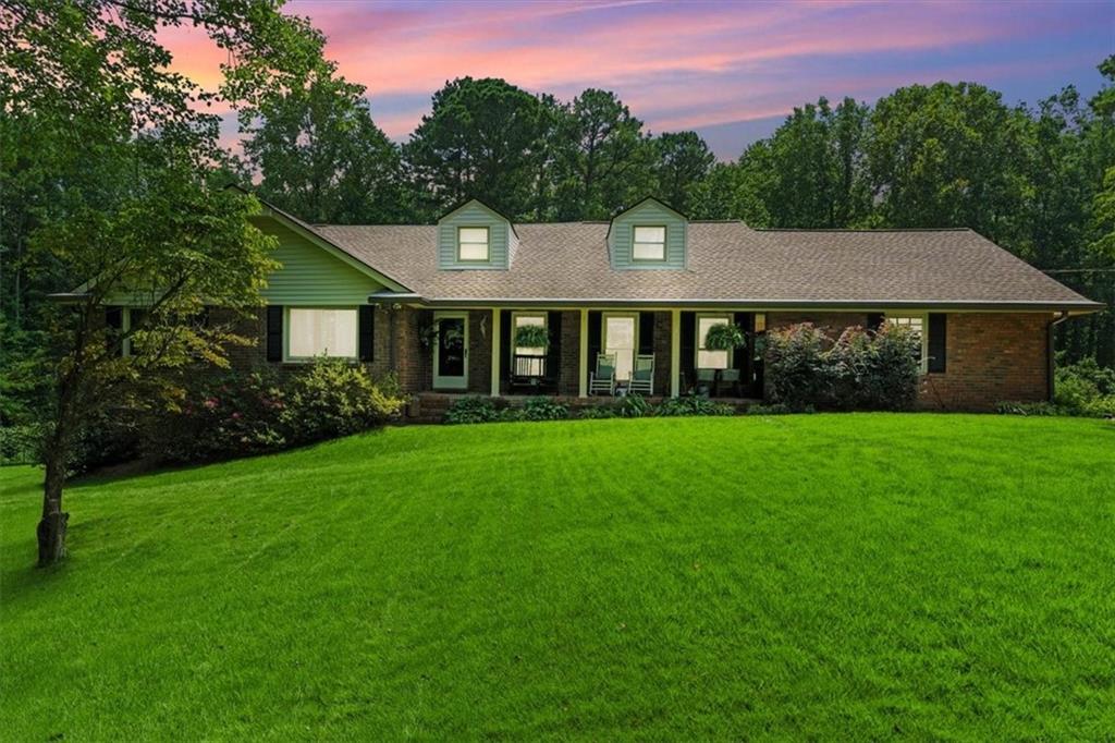 a front view of a house with a garden
