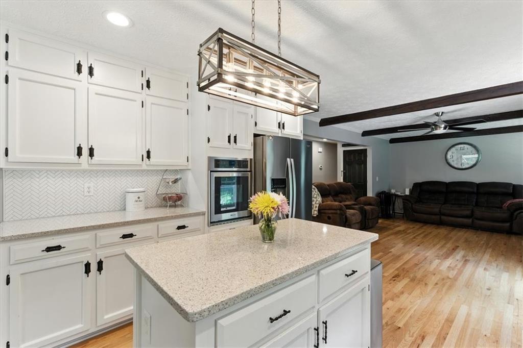 4970 Nebo Road Hiram, GA 30141 - Photo 11 of 61 a kitchen with stainless steel appliances granite countertop a sink cabinets and wooden floor