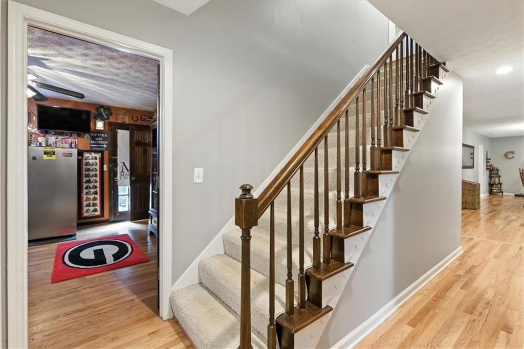 4970 Nebo Road Hiram, GA 30141 - Photo 14 of 61 a view of a hallway with wooden floor and staircase