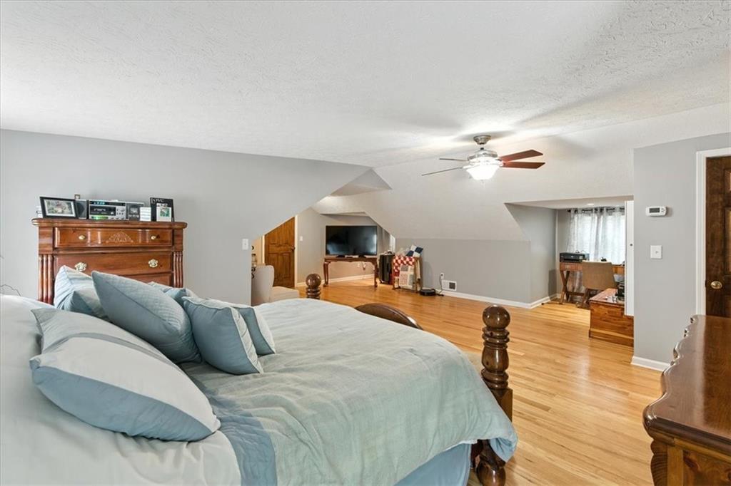 4970 Nebo Road Hiram, GA 30141 - Photo 17 of 61 a bedroom with a bed and wooden floor