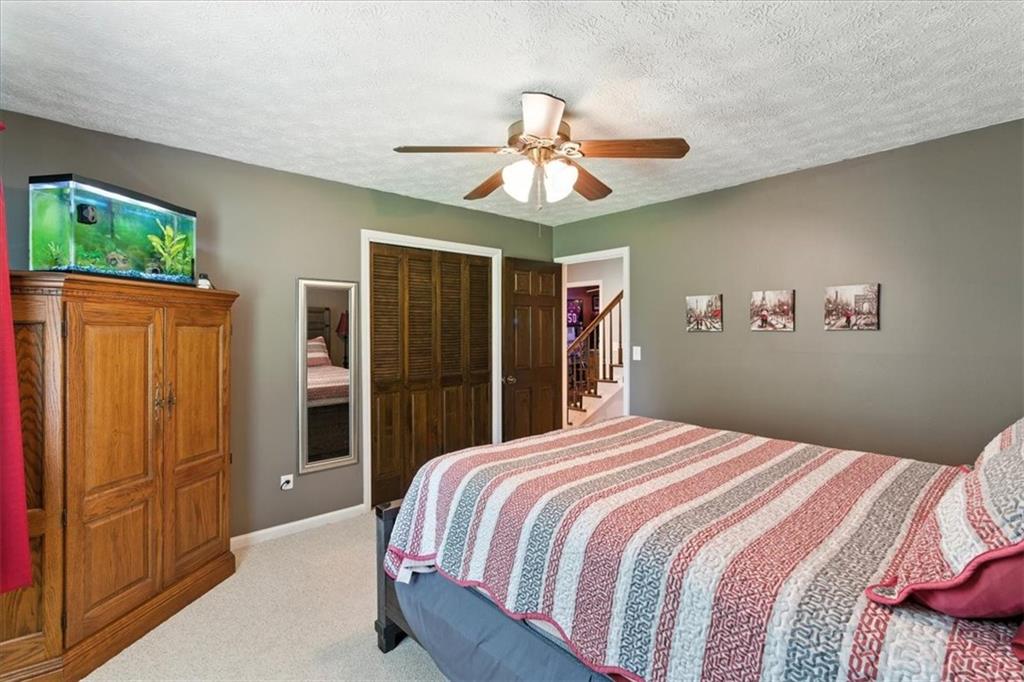 4970 Nebo Road Hiram, GA 30141 - Photo 24 of 61 a bedroom with a large bed and a chandelier