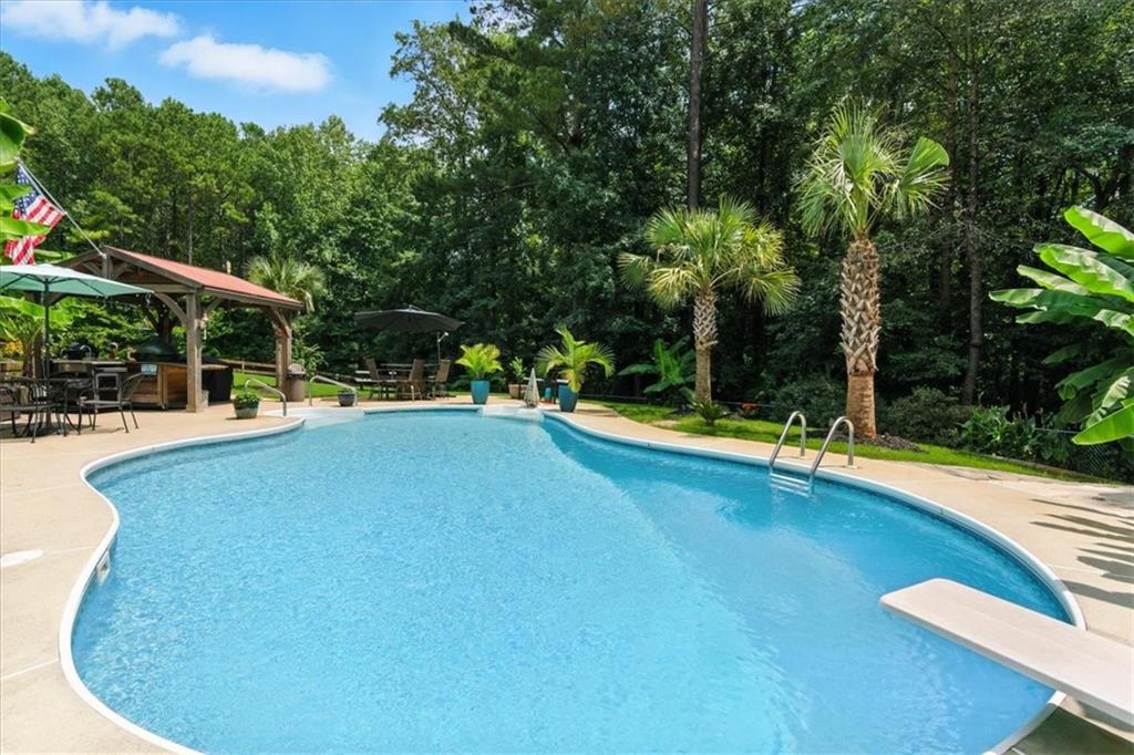 4970 Nebo Road Hiram, GA 30141 - Photo 36 of 61 a view of a swimming pool with an outdoor seating and a garden