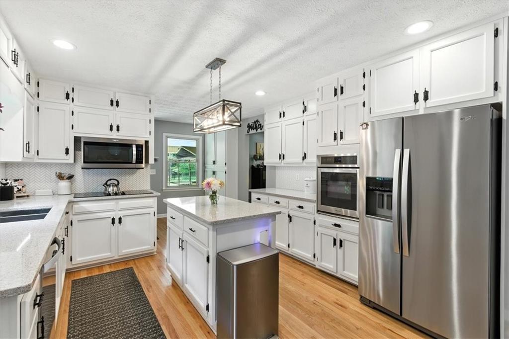 4970 Nebo Road Hiram, GA 30141 - Photo 9 of 61 a kitchen with stainless steel appliances a stove refrigerator sink and microwave