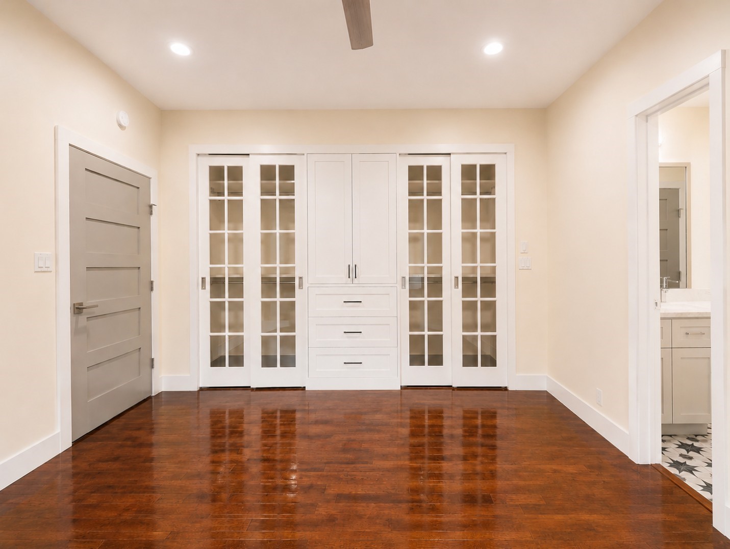 2302 Ruth Street Houston, TX 77004 - Photo 8 of 18 The 1st floor primary features glass paned sliding doors opening to a wall of closet space.