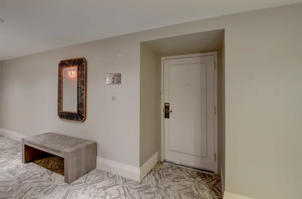 a view of a dining room with furniture a chandelier and wooden floor