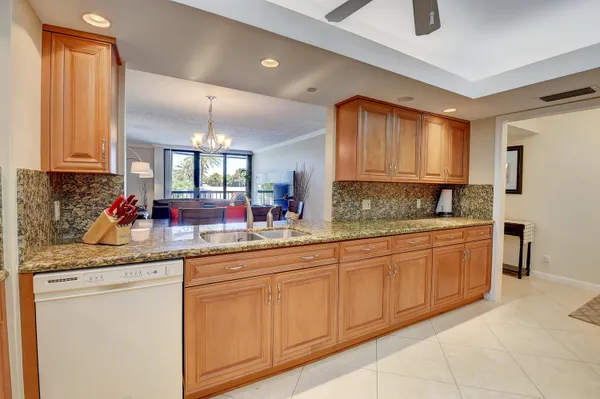 a bedroom with a bed a lamp and a large window