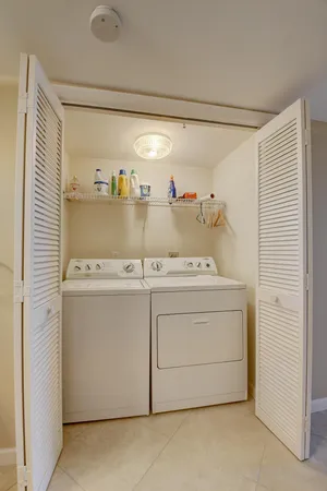 a view of a balcony with two chairs and a table
