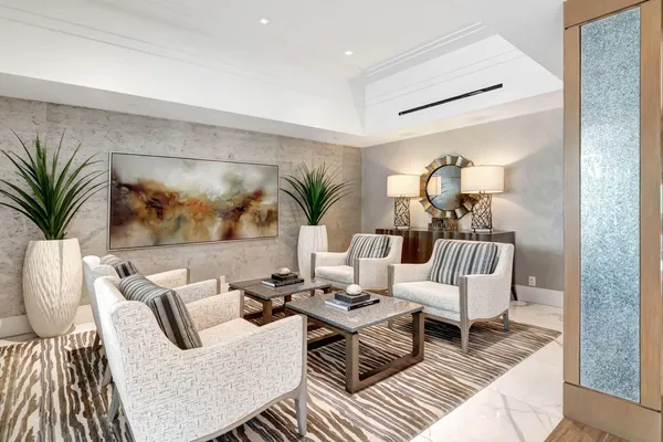 a living room with furniture and a potted plant