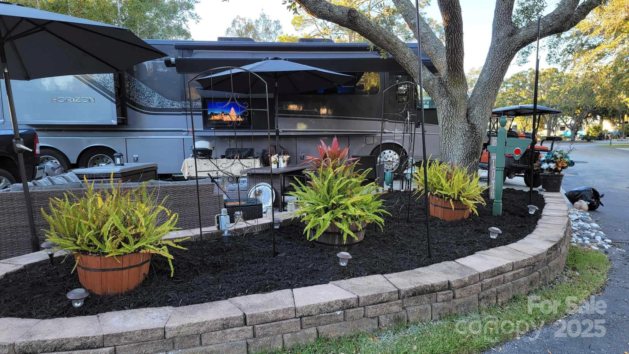43B Jenkins Island Road, Unit 177 Hilton Head Island, SC 29926 - Photo 7 of 17 a potted plant sitting in front of a house